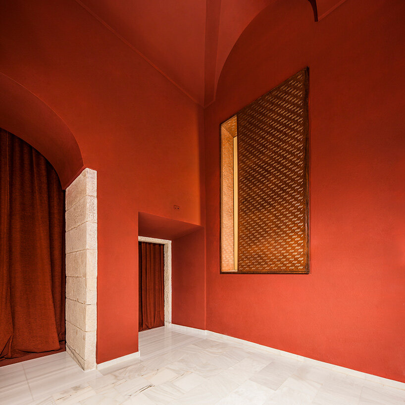 BACH converts reina sofía's auditorium into red-velvet cinema beneath blue vault in madrid