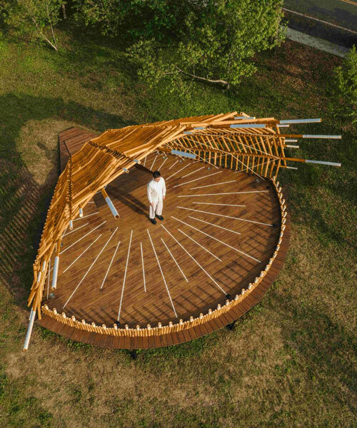 interwoven bamboo poles fan outward to form theater stage by cheng tsung feng