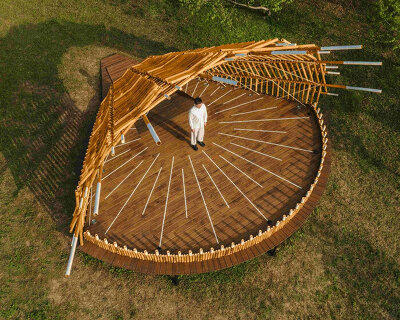 interwoven bamboo poles fan outward to form theater stage by cheng tsung feng