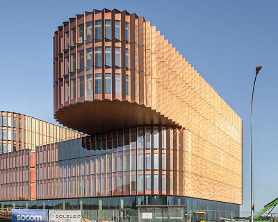 BIG's timber 'snakes' rise as skypark business center nears completion in luxembourg