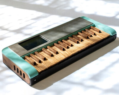 cardboard synthesizer plays sounds using handmade wooden keys cut from walnut and oak
