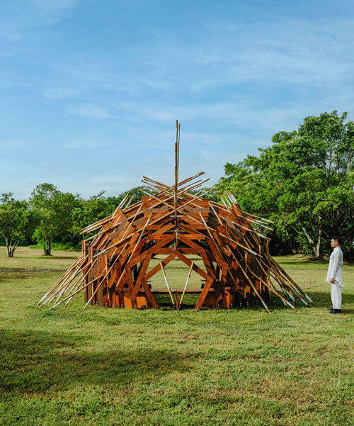 interlocking bamboo and cedar frames shape wild boar nest installation by cheng tsung feng