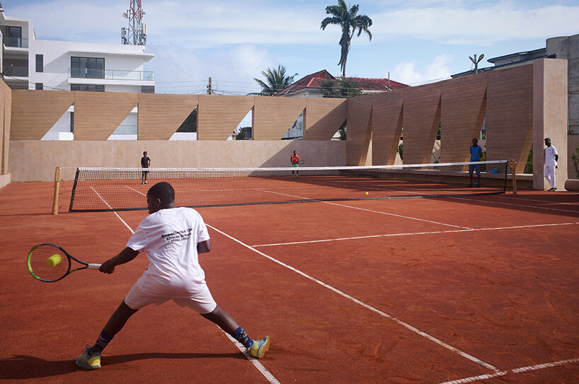 ghana’s first precast rammed earth project by deroche projects hosts community tennis court