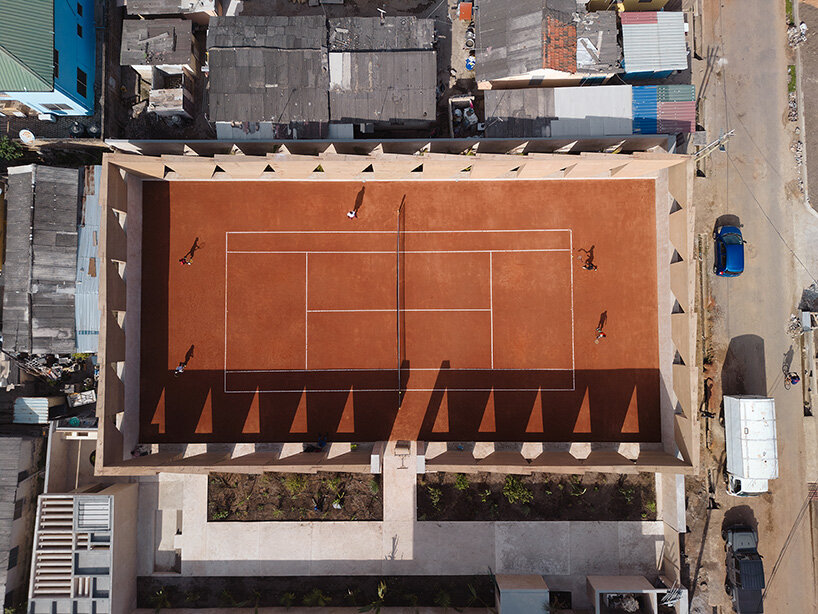 ghana’s first precast rammed earth project by deroche projects hosts community tennis court