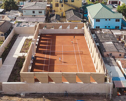 ghana's first precast rammed earth project by deroche projects hosts community tennis court