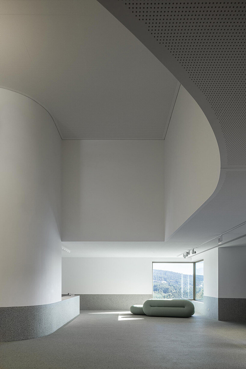 green cork skin camouflages galeria gabinete's portuguese cultural center into its lush setting