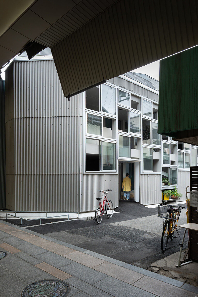 grid of operable windows fronts slender residence by okuwada architects in osaka