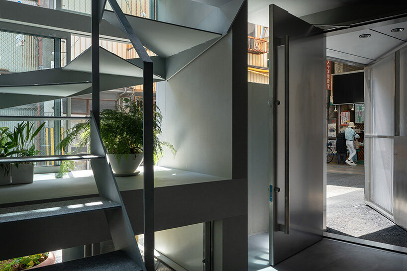 grid of operable windows fronts slender residence by okuwada architects in osaka