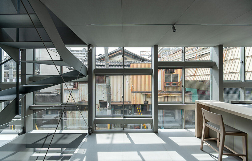 grid of operable windows fronts slender residence by okuwada architects in osaka