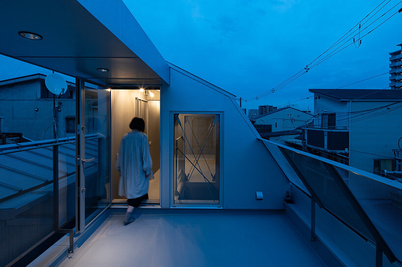 grid of operable windows fronts slender residence by okuwada architects in osaka