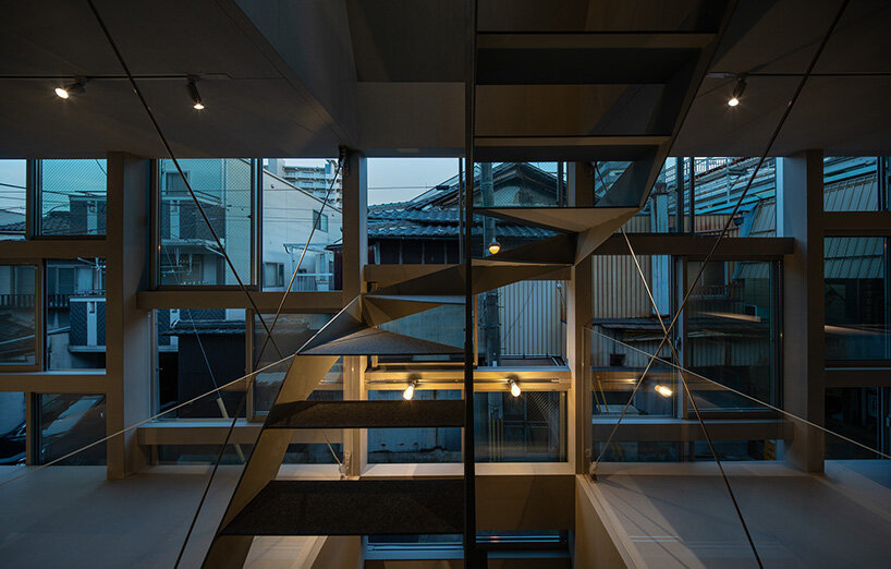 grid of operable windows fronts slender residence by okuwada architects in osaka