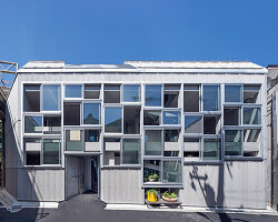 grid of operable windows fronts slender residence by okuwada architects in osaka