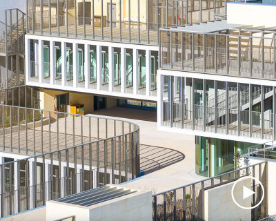 interlocking stone volumes sculpt layered school complex by brenac & gonzalez & associés