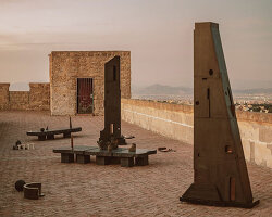 totemic sculptures compose volcanic stone landscape for site-specific installation in naples