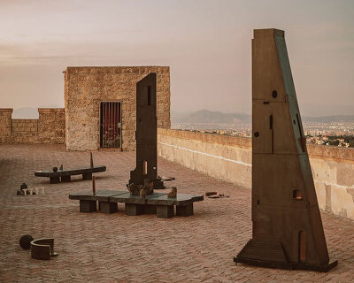 totemic sculptures compose volcanic stone landscape for site-specific installation in naples