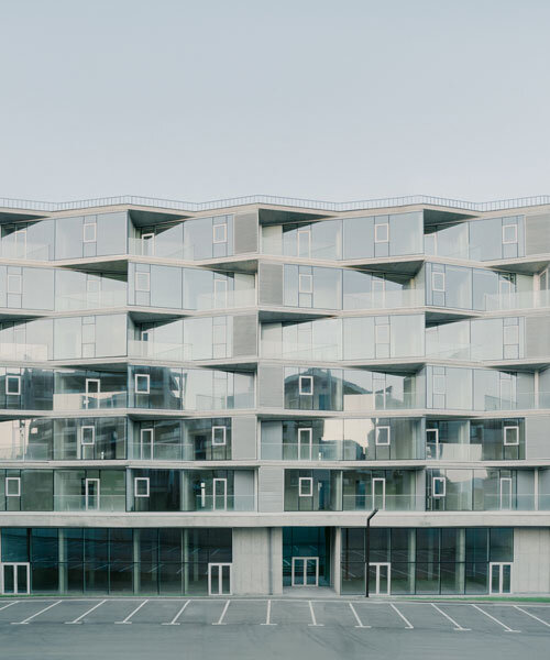 prismatic glass facade enfolds residential unit’s concrete modular framework in georgia