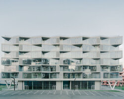 prismatic glass facade enfolds residential unit’s concrete modular framework in georgia