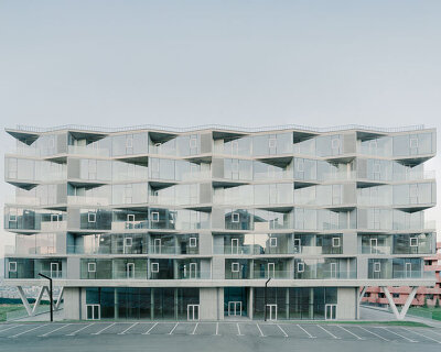 prismatic glass facade enfolds residential unit’s concrete modular framework in georgia