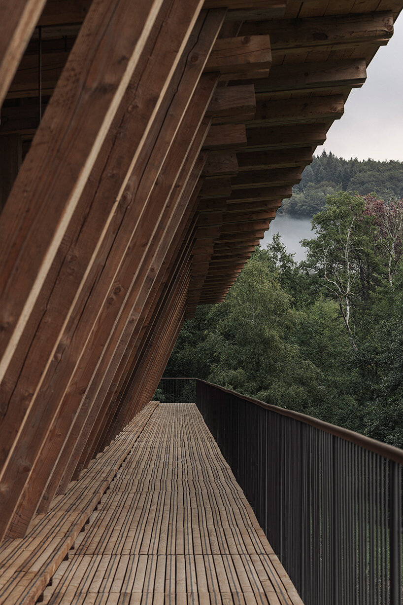 local stone and timber shape self-sufficient riverbank house by BC architects in belgium
