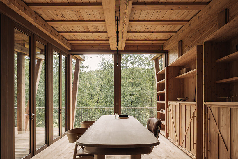 local stone and timber shape self-sufficient riverbank house by BC architects in belgium