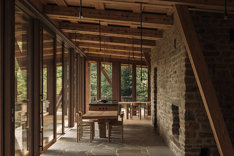 local stone and timber shape self-sufficient riverbank house by BC architects in belgium