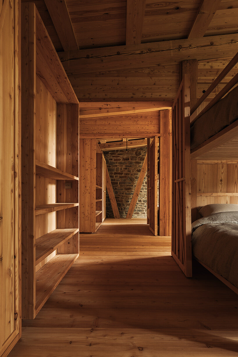 local stone and timber shape self-sufficient riverbank house by BC architects in belgium