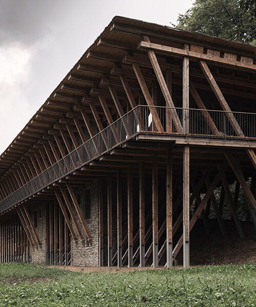 local stone and timber shape self-sufficient riverbank house by BC architects in belgium
