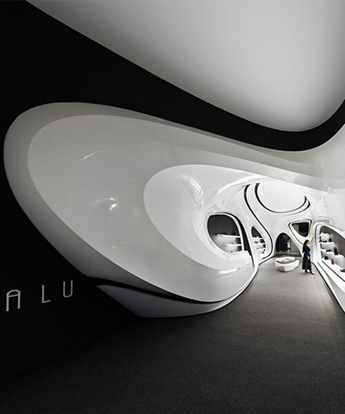 fluid black and white interiors connect curved mall corridors in tehran