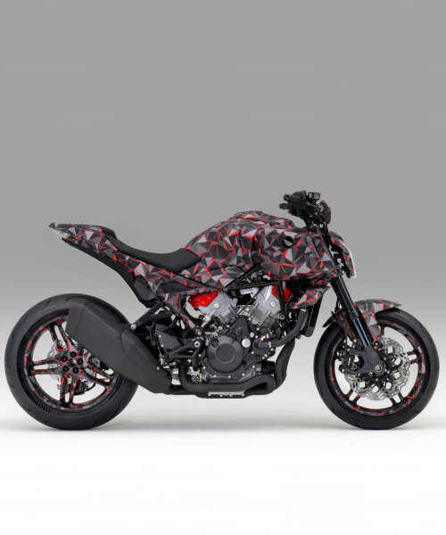 naked motorcycle by honda exposes the engine around the camouflage-wrapped frame