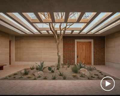 rammed-earth residence unfolds around central planted courtyard on mexico's coast