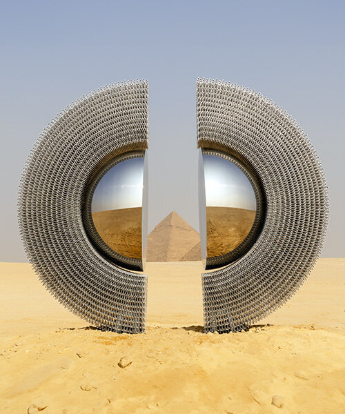 reflective aluminum sculpture by mert ege köse splits apart to frame the giza pyramids