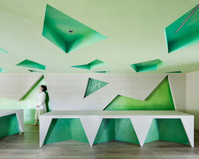 polygonal green cutouts animate kakushin tokyo office's interiors by moriyuki ochiai