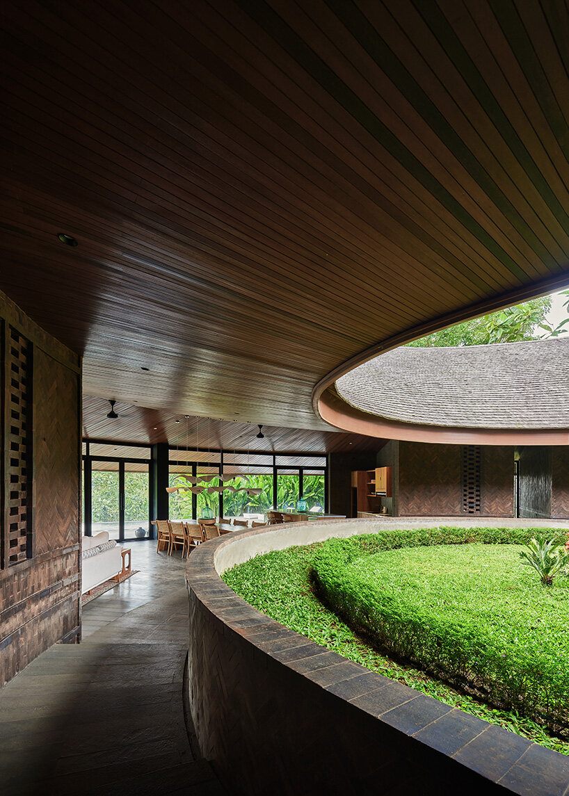 ring-shaped residence by alexis dornier wraps around verdant inner courtyard in bali