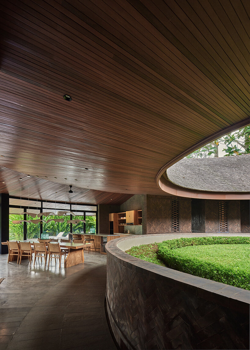 ring-shaped residence by alexis dornier wraps around verdant inner courtyard in bali