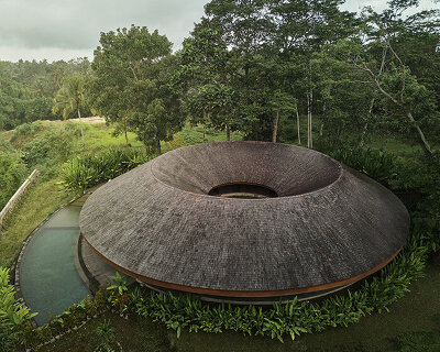 ring-shaped residence by alexis dornier wraps around verdant inner courtyard in bali