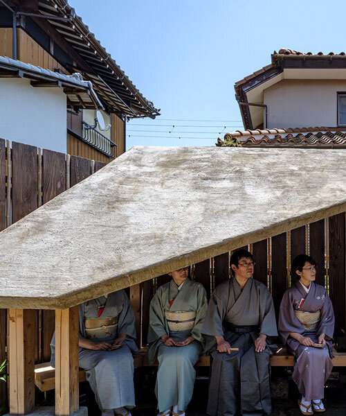 moss-covered earthen roof shields teahouse’s waiting area in japan