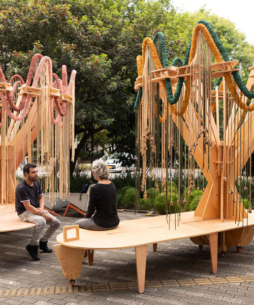 plywood and fabric solar tree installations offer shade in colombia's urban open spaces