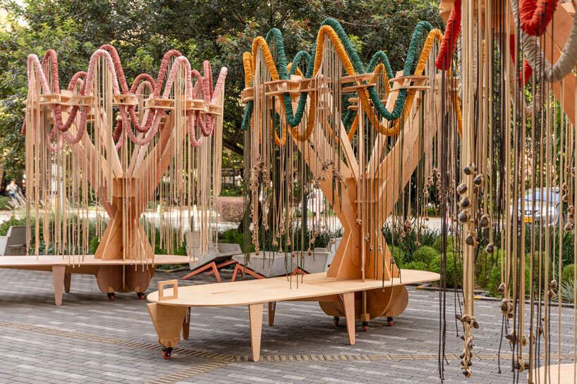 plywood and fabric solar tree installations offer shade in colombia's urban open spaces