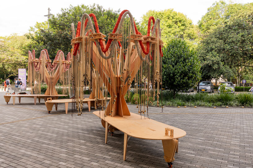plywood and fabric solar tree installations offer shade in colombia's urban open spaces