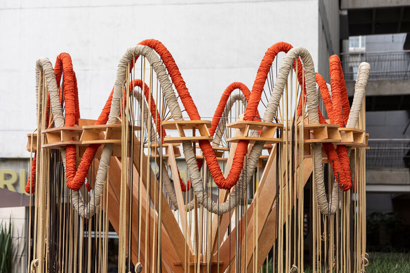 plywood and fabric solar tree installations offer shade in colombia's urban open spaces