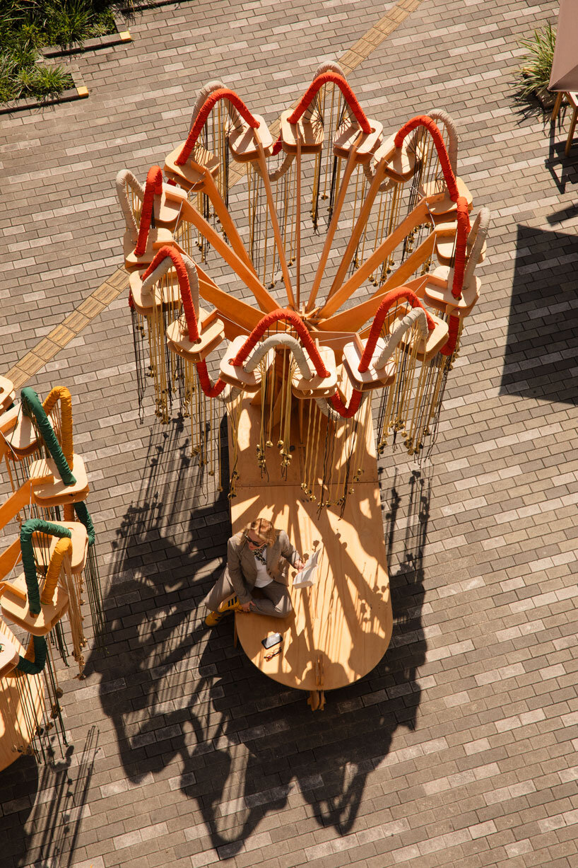 plywood and fabric solar tree installations offer shade in colombia's urban open spaces