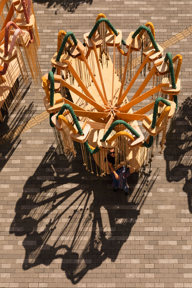 plywood and fabric solar tree installations offer shade in colombia's urban open spaces