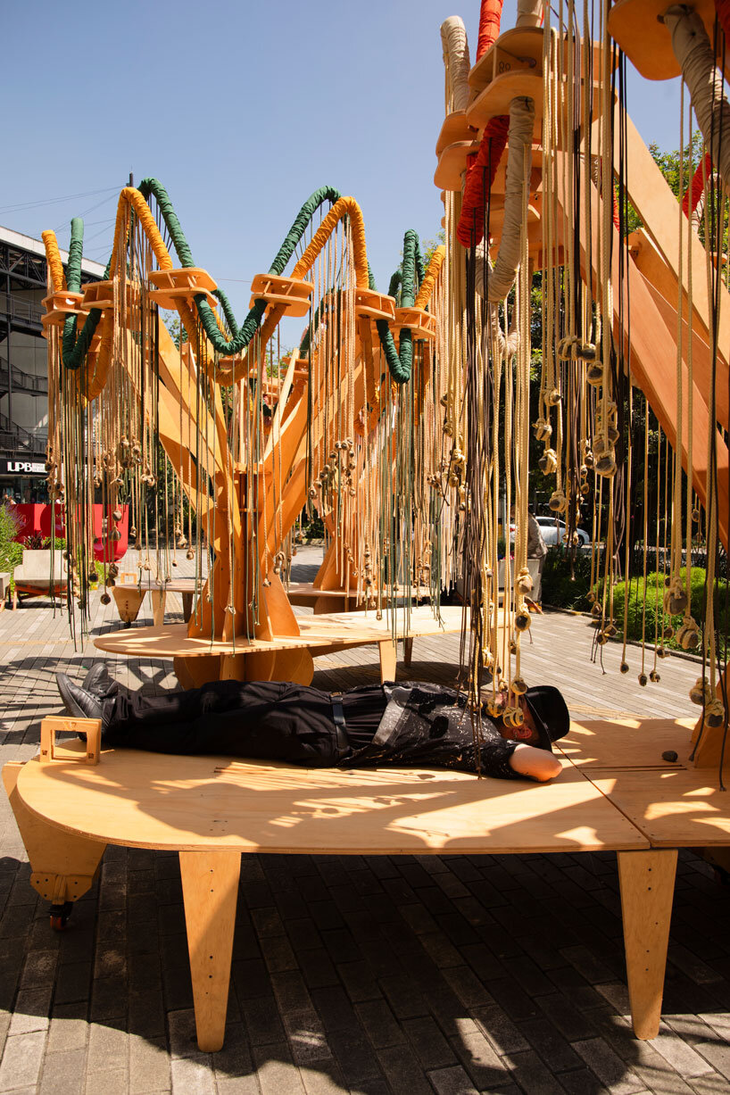 plywood and fabric solar tree installations offer shade in colombia's urban open spaces