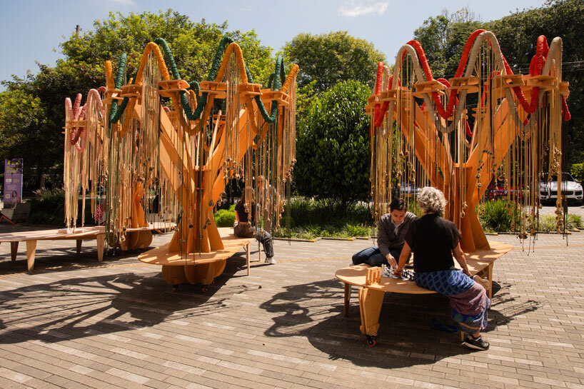 plywood and fabric solar tree installations offer shade in colombia's urban open spaces