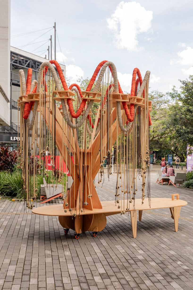 plywood and fabric solar tree installations offer shade in colombia's urban open spaces