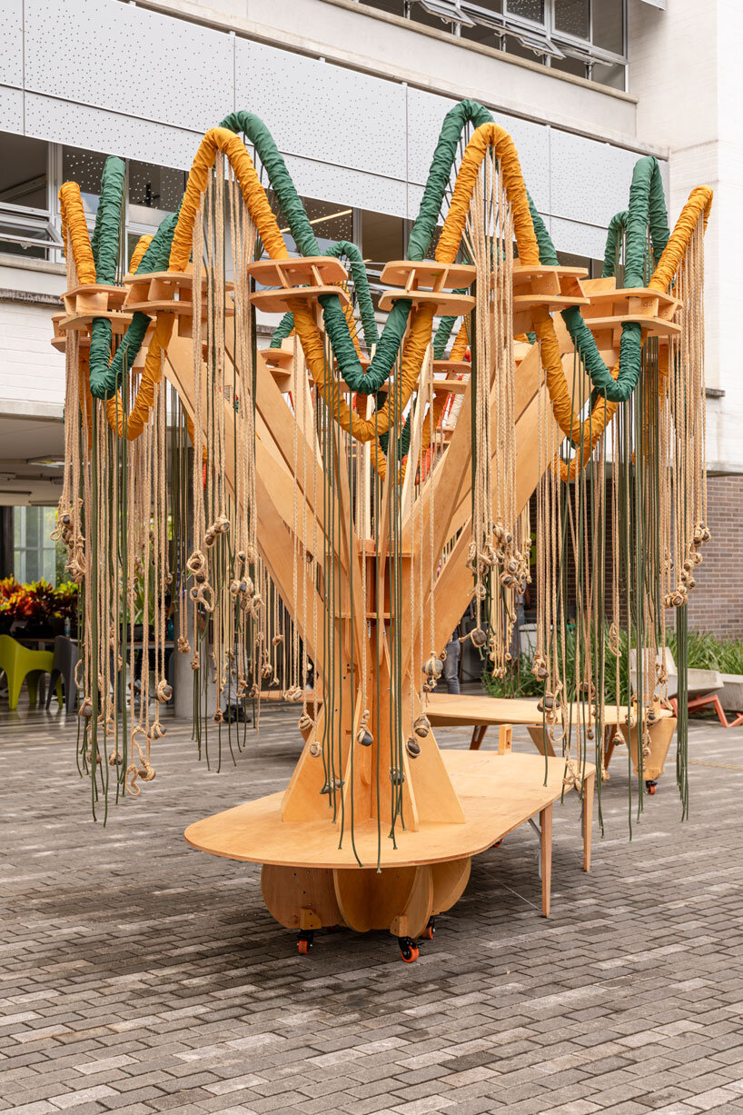 plywood and fabric solar tree installations offer shade in colombia's urban open spaces