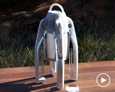 spider-like drone made to deliver beer cans drops them using mini parachutes