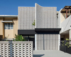porous white brickwork facade enfolds renovated 1980s terrace house in kuala lumpur