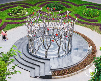a circle of mirroring steel branches composes a luminous forest in hanoi's public realm