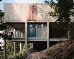 concrete columns lift residence above forested terrain in georgia